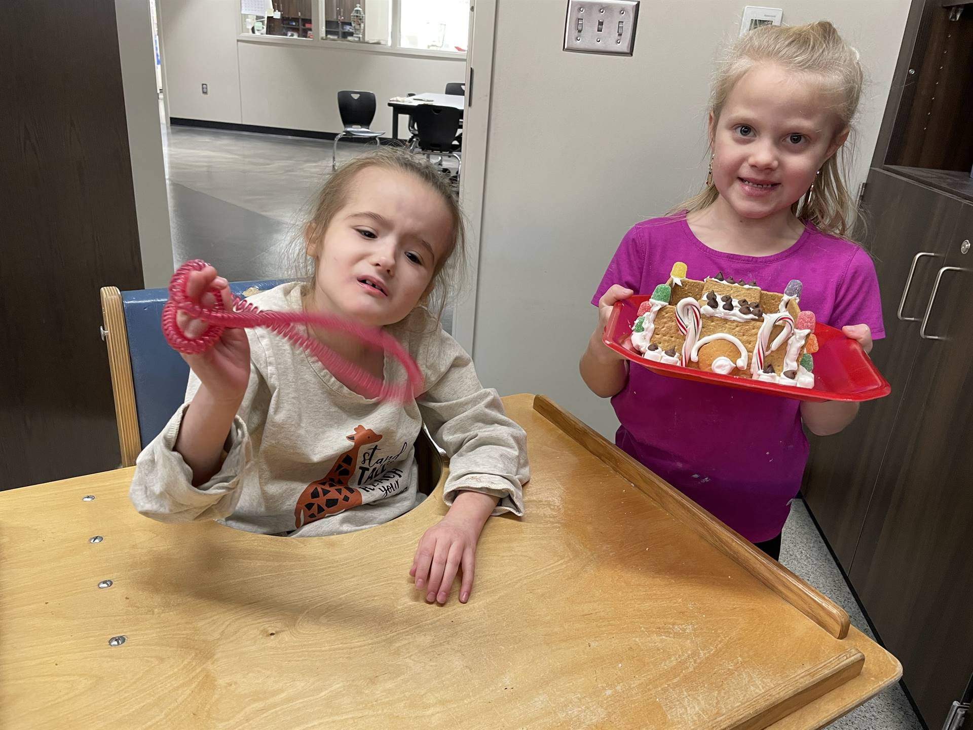 Skye & Maleah with gingerbread house