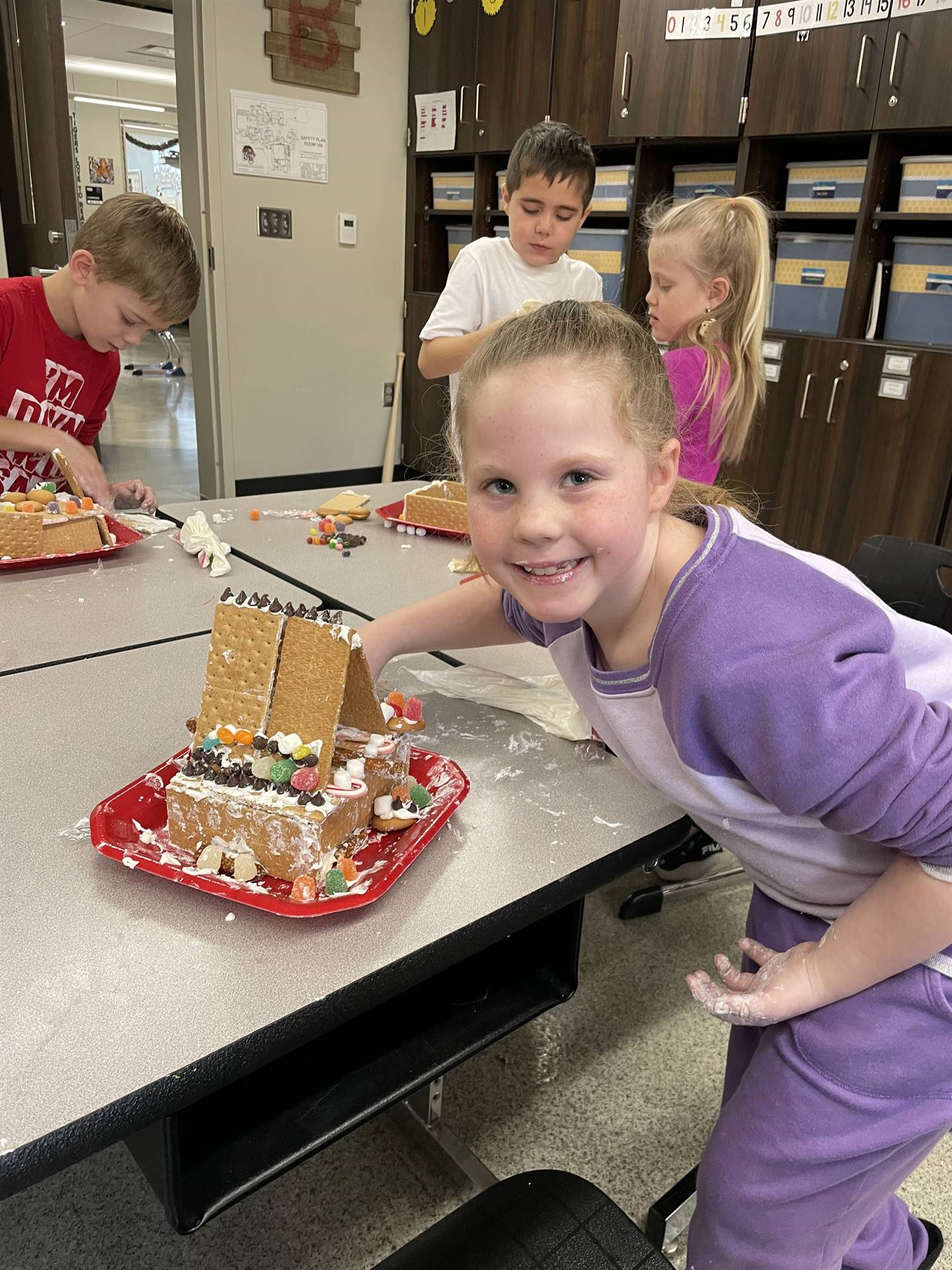 Nevaeh with gingerbread house