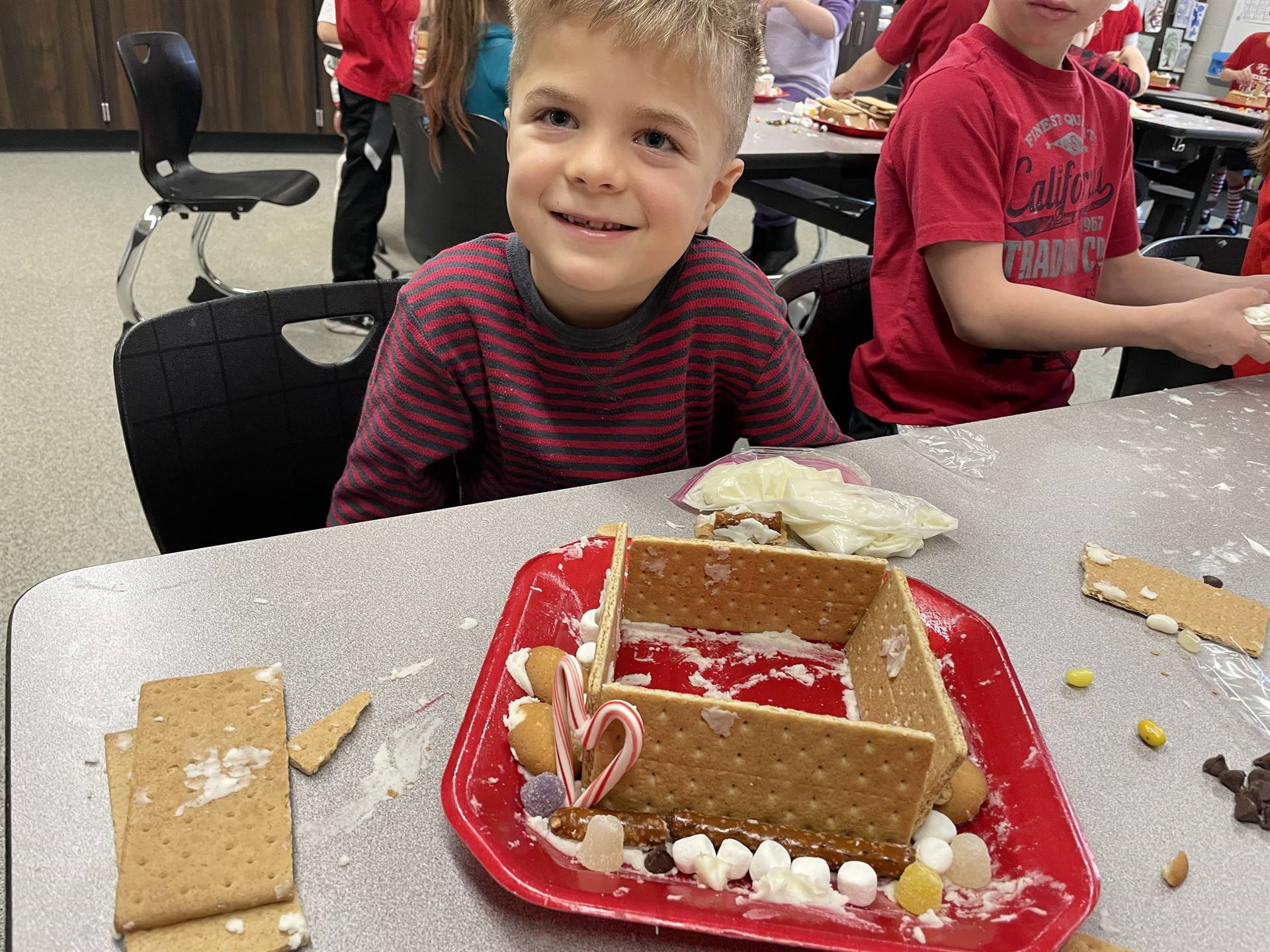 Eli with gingerbread house