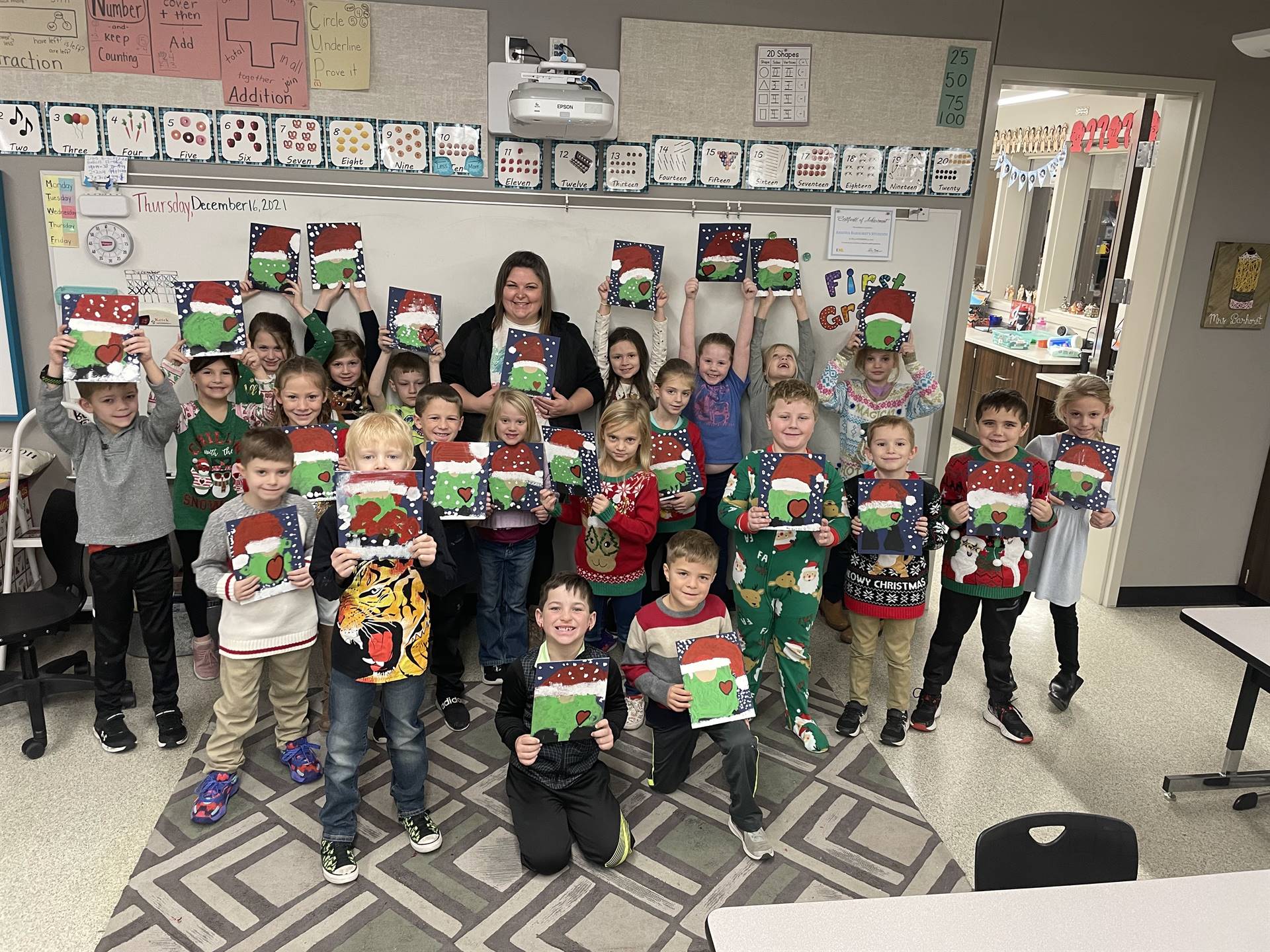 Class with Ms Amber showing grinch gnome paintings