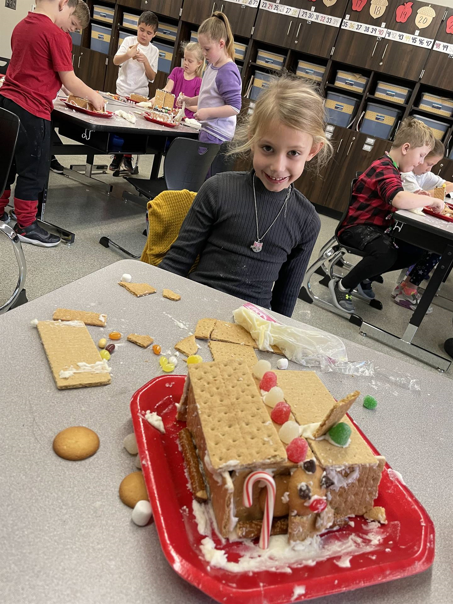 Avery with gingerbread house