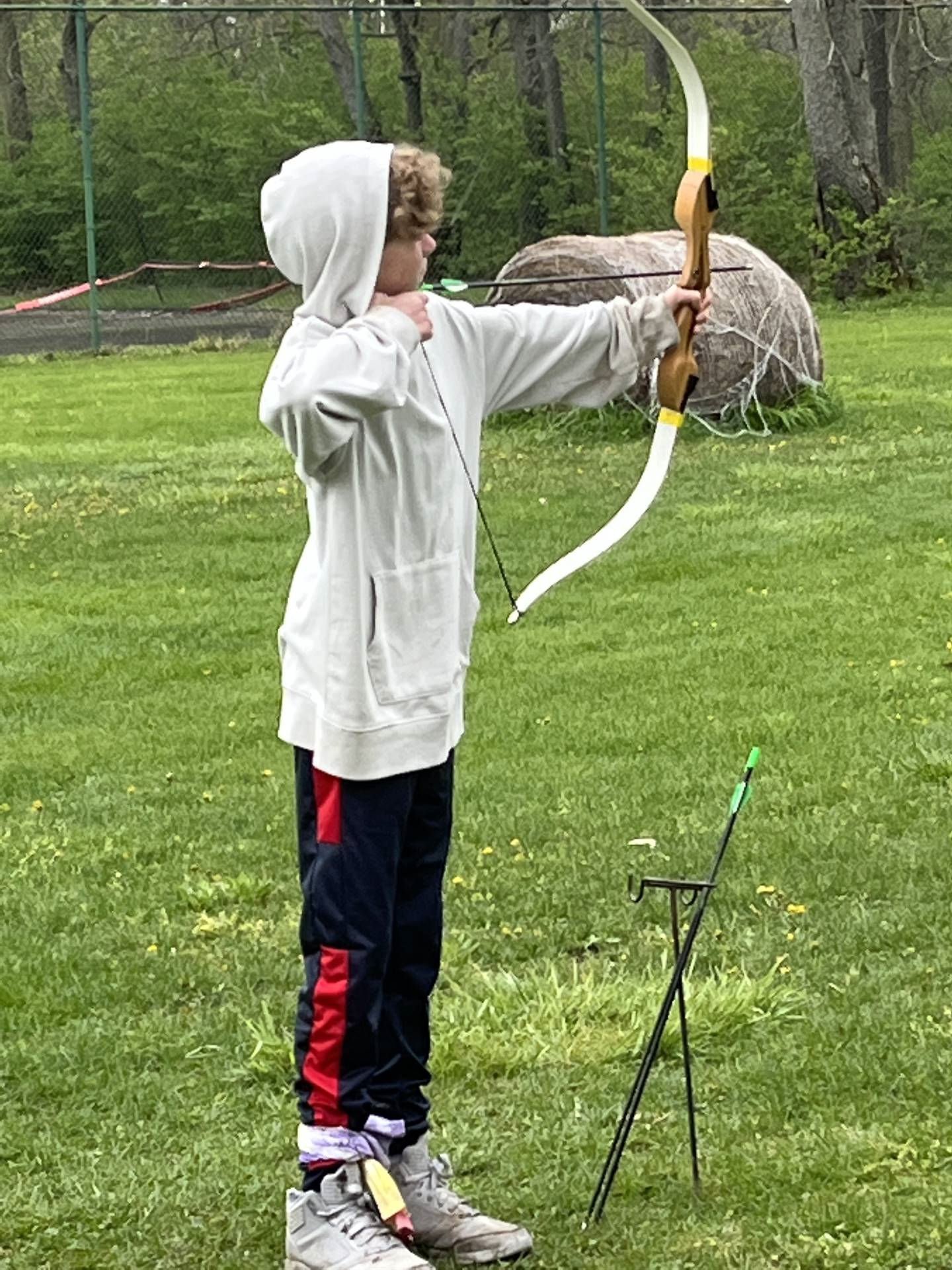 student shooting arrow at camp willson