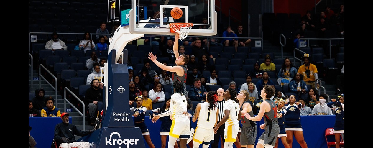 JC Basketball player shooting basket at Districts