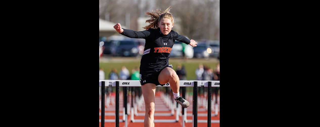 Track girl running hurdles
