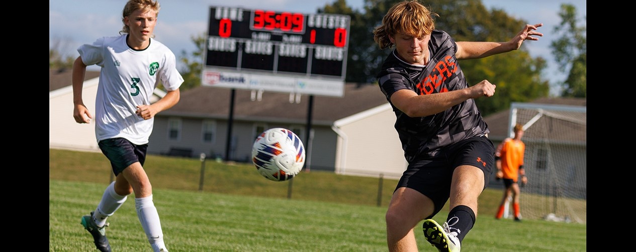 Soccer player kicking the ball for a pass