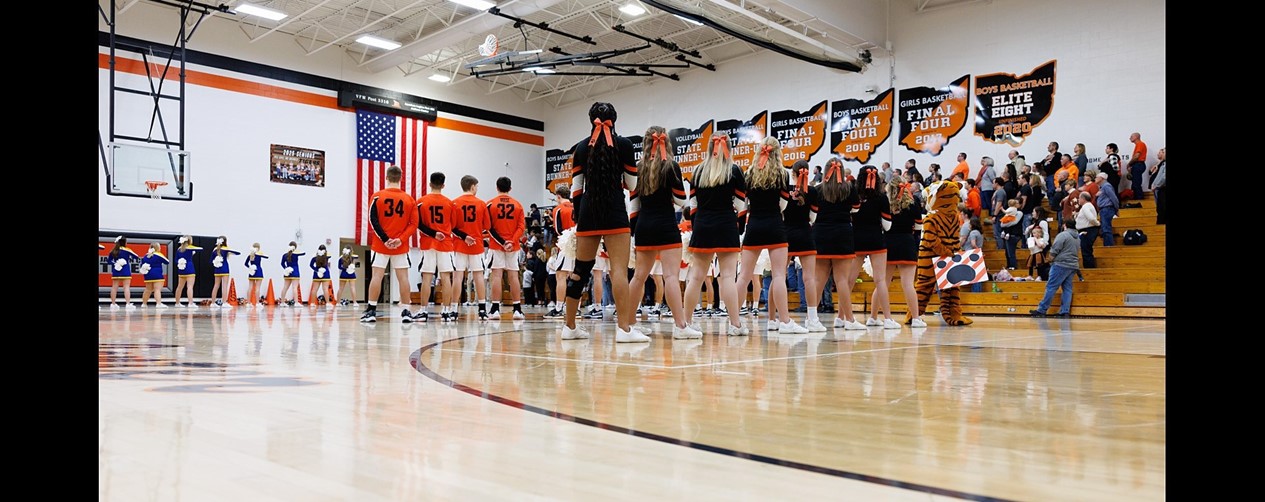 cheerleaders and boys basketball players before game