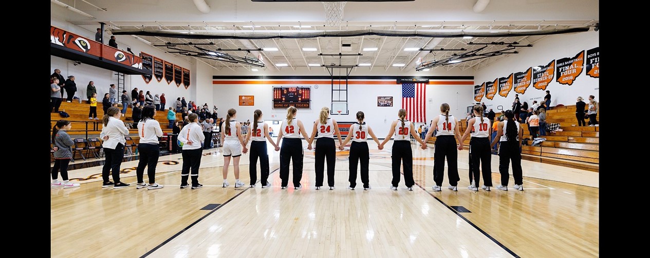 high school girls basketball team before game on floor